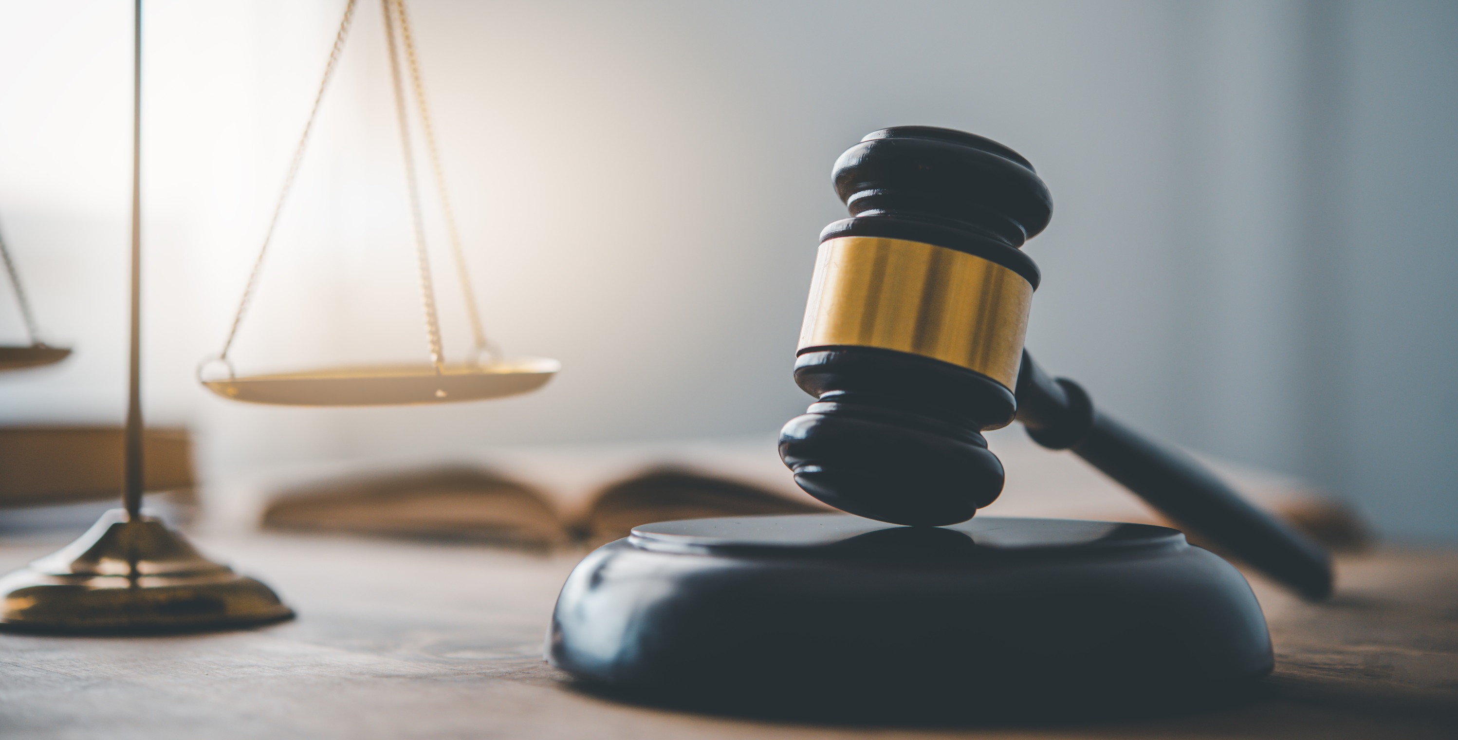 Scales of justice and gavel on a solicitor's desk